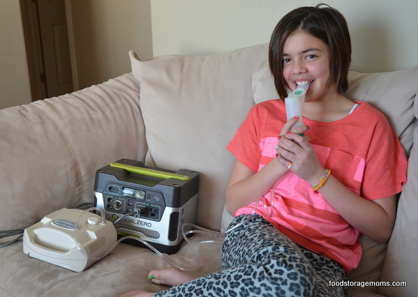 little girl using the nebulizer with out power