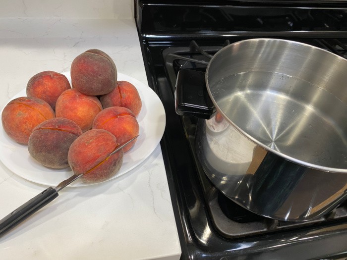 Cut the peaches in half