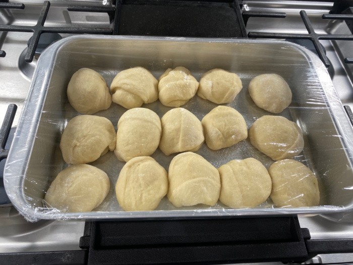 Dinner Rolls Covered With Plastic Wrap To Rise