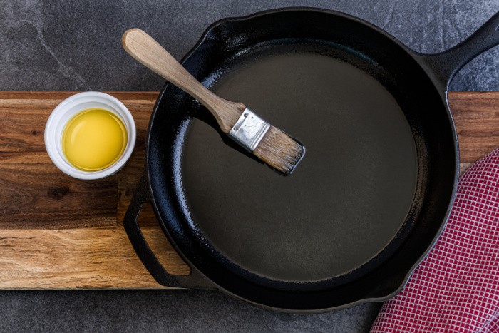 https://www.foodstoragemoms.com/wp-content/uploads/2019/05/Cast-Iron-Being-Oiled-.jpeg