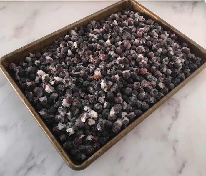 Place the frozen blueberries on a cookie sheet to thaw