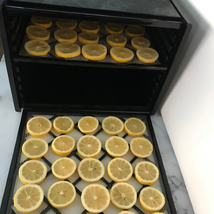 Place the lemons on the dehydrating racks.