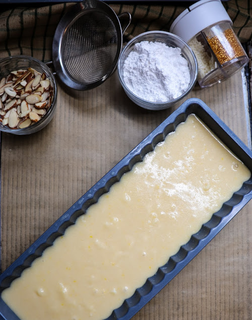 Pouring the almond cake batter into the pan