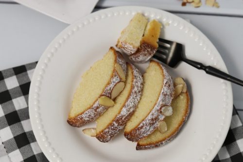 Slices of Almond Cake on a white plate with a fork