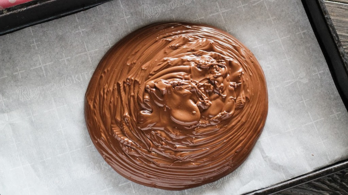 Spreading the chocolate on the parchment paper