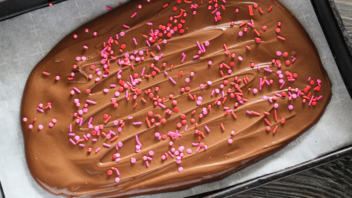 Spread the chocolate evenly on the cookie sheet