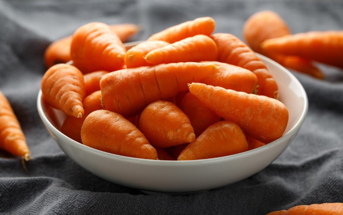 Chantenay carrots in a white bowl