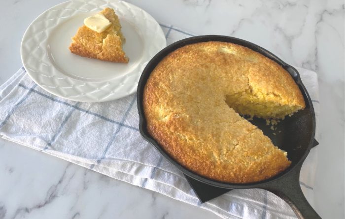 Cornbread cut and on a white plate