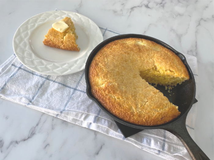 Cornbread cut and on a white plate