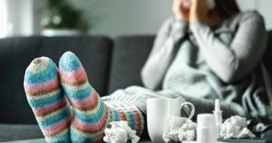 Sick woman with Influenza sitting on a couch