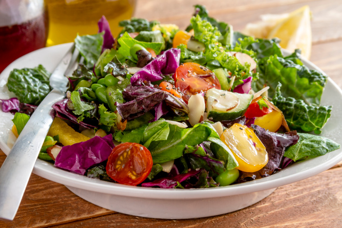 Kale salad on a white bowl