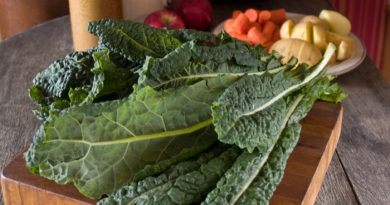 Kale laying on wood cutting board