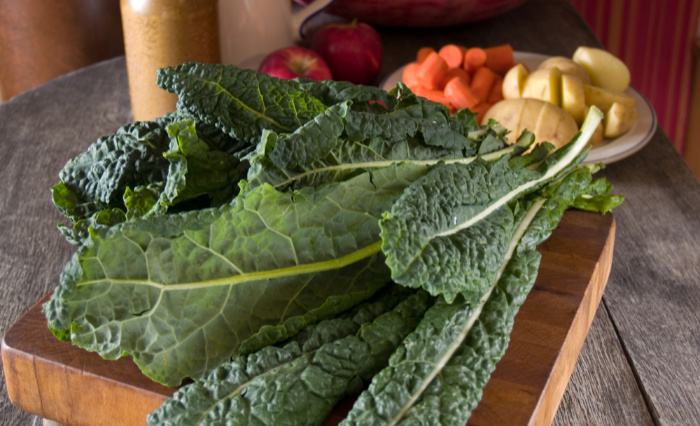 Kale laying on wood cutting board