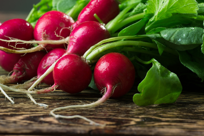 Bunch of radishes on wood