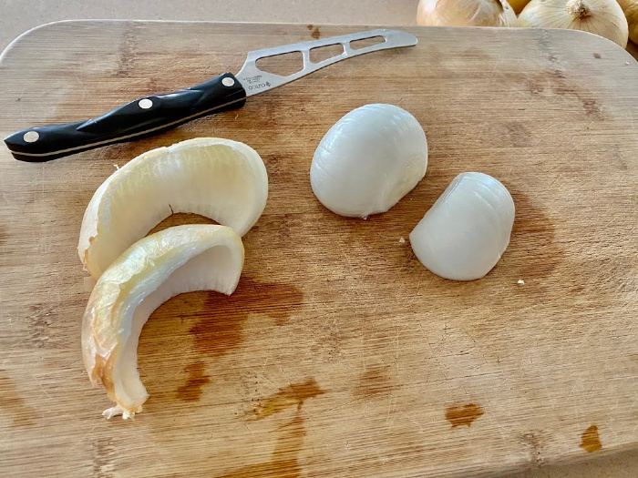 Cutting onions on wooden board