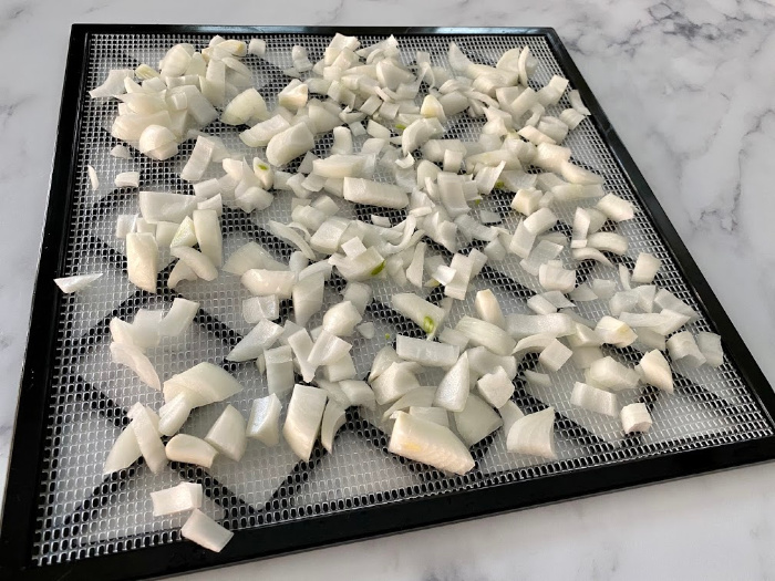 Copped onions on a dehydrator rack