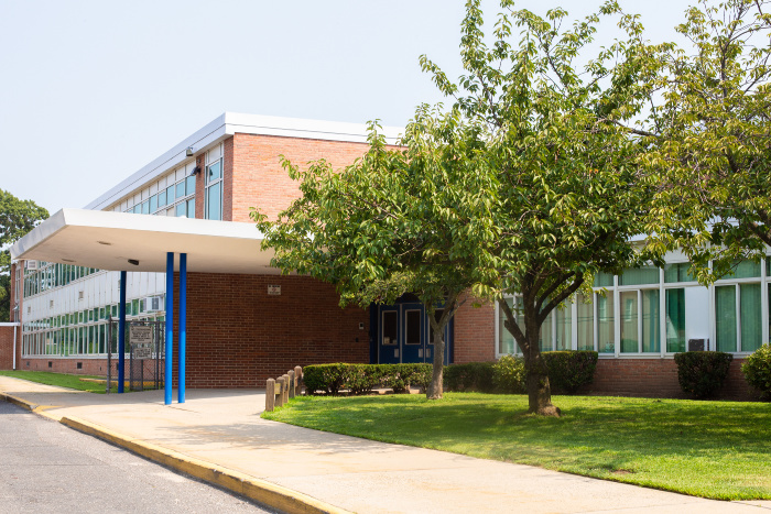 Picture of a school with grass and trees