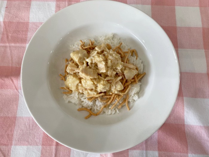 Make a base for the Hawaiian Haystacks using the cooked rice, topped with the Chinese crispy noodles. Now, add a scoop of the chicken gravy mixture.