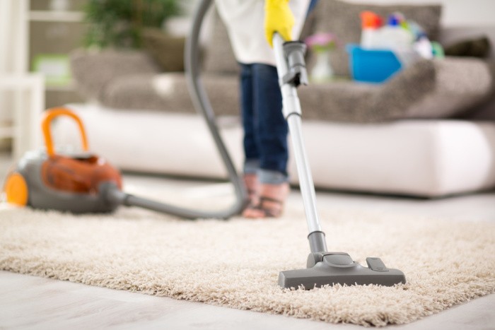 Woman Vacuuming Carpet