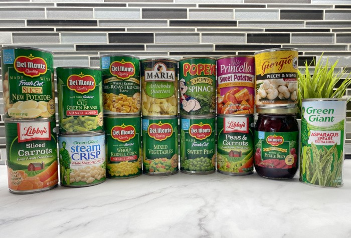 Canned Vegetables Lined Up On Countertop