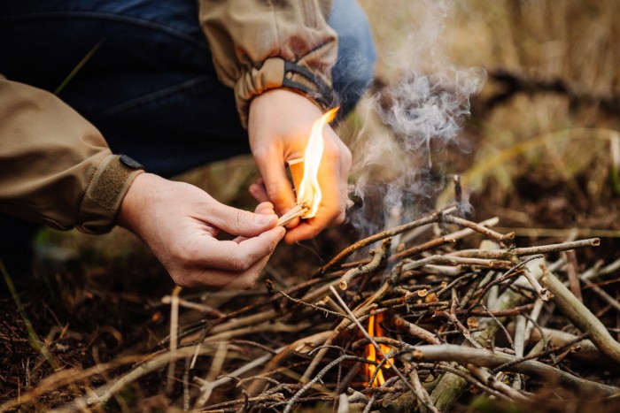 Starting a Fire by a Young Man