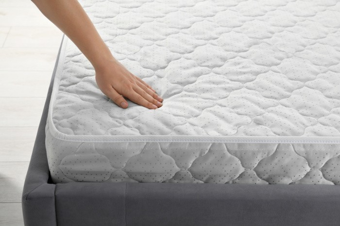 Mattress with Hand On It