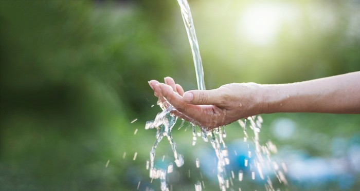 Water Pouring In Woman's Hand