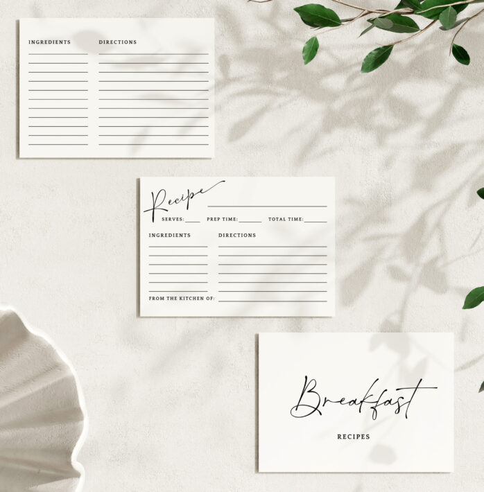 Three views of a printable recipe card template (front, back, and divider) arranged on a textured wall with leaf shadows.
