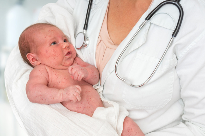 Doctor With Stethoscope Holding Baby