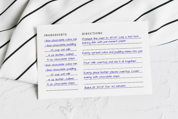 The back side of a printable recipe card template filled out with directions for a chocolate dump cake recipe in blue ink.