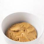The formed dough ball made of peanut butter oat flour base for no bake peanut butter bars.