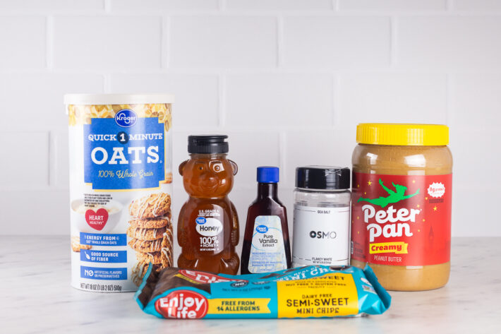 Ingredients for no bake peanut butter bars including oats, peanut butter, honey, flakey salt, and chocolate chips