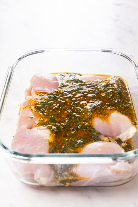 Pouring the Marinade on The Oven Baked Lemon Pepper Chicken Thighs Recipe