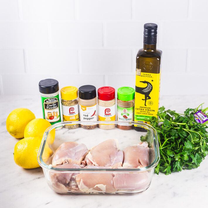 Ingredients Used for the Oven Baked Lemon Pepper Chicken Thighs Recipe - Chicken, lemons, parsley, olive oil, lemon pepper seasoning, garlic powder, red pepper flakes, onion powder, and smoked paprika